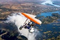 Tourists fly over the Victoria Falls on the trikes. Royalty Free Stock Photo